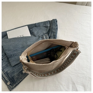 Top view of beige bucket bag showing large capacity for tablet, wallet and accessories