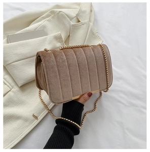 Elegant beige velvet crossbody bag with vertical quilted stripes and gold chain strap