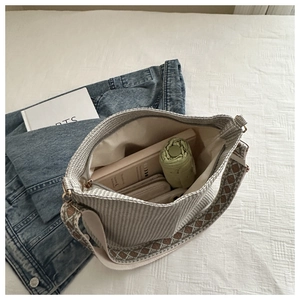 Interior view showing large capacity for umbrella and phone in striped tote bag