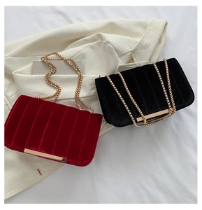 Detail of velvet chain bags with vertical pleats and golden metal hardware finish
