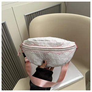 Detail of white bubble textured crescent waist bag with pink zipper and nylon strap