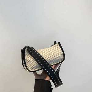 Woven straw underarm bag with studded leather strap and contrast piping detail