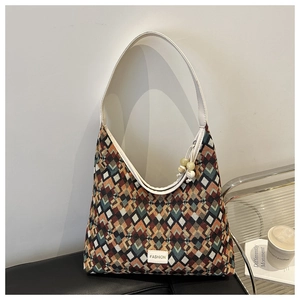 Detail of colorful geometric jacquard nylon tote bag with white leather handle and charms