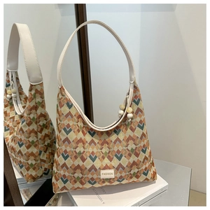 Detail of hobo bag with colorful geometric diamond texture and marble bead charm