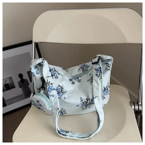 Détail du sac à épaule en velours côtelé bleu clair fleuri avec son petit porte-monnaie