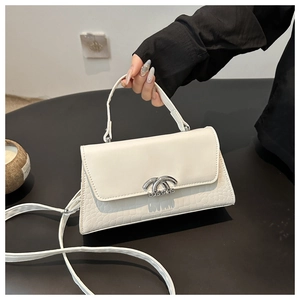 Detail of white crocodile texture leather bag with silver LOST YACHTS metal buckle