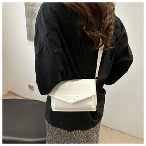 White minimalist crossbody bag with Fashion & Bags print worn on shoulder by model