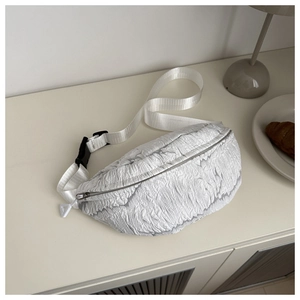 Detail of white pleated texture fabric and black plastic buckle on stylish crossbody bag
