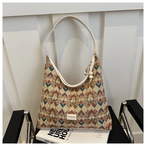 Detail of geometric knit pattern on tote bag with leather Fashion tag and slim strap