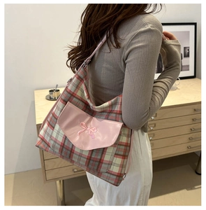 Close-up of a large Korean-style tote bag with red, white, and green plaid fabric and bow
