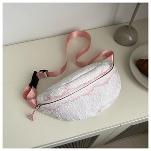 Detailed close-up of textured tie-dye waist bag with pink nylon strap and buckle
