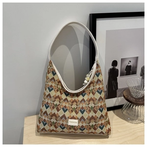 Detail of retro geometric wave pattern shoulder bag with a white fashion label on wood