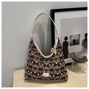 Detail of vintage geometric jacquard pattern on a nylon tote bag with leather strap