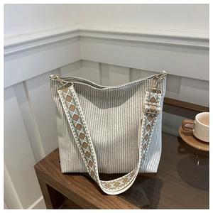 Detailed shot of woven hobo bag with ethnic geometric embroidery wide shoulder strap