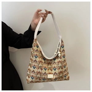Detail of geometric jacquard fabric and beaded ornament on the nylon shoulder bag