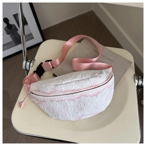 Detail of pink and white jacquard chest bag showing fabric texture and buckle