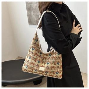 Detail of hobo shoulder bag featuring geometric rhombus pattern and decorative beads