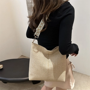 Straw style bucket bag with wide ethnic pattern strap and large capacity for women