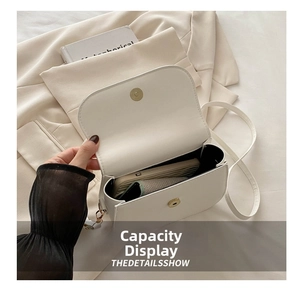 Interior view showing the large capacity of the white leather saddle bag for a smartphone