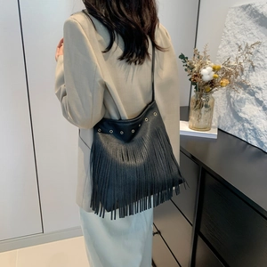Retro bohemian black leather tote bag with long fringe tassels and golden metal eyelets