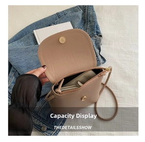 Interior detail of beige bucket bag showing capacity for phone and wallet on denim jacket
