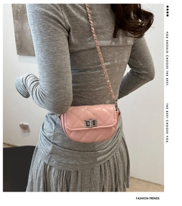 Détail du mini sac matelassé rose avec chaîne dorée et fermoir pivotant en métal classique