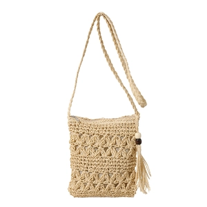 Handwoven straw crossbody bag with zipper closure and bohemian tassel wood bead detail