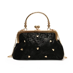 Vintage black evening handbag with gold heart studs and ornate floral metal handle