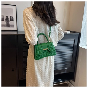 Vue de dos d'un mannequin portant un sac bandoulière vert vif matelassé avec fermoir doré