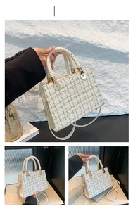 Detail of tweed handbag in white gold weave with textured fabric and gold metal hardware