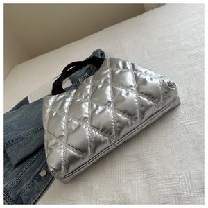 Détail du cabas matelassé argenté avec texture métallique et bandoulière noire