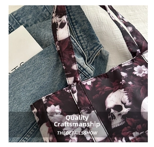 Detailed stitching on shoulder strap of skull and floral print oxford tote bag