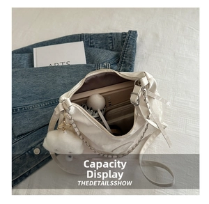 Interior view of the white shoulder bag showing large capacity for books and umbrellas