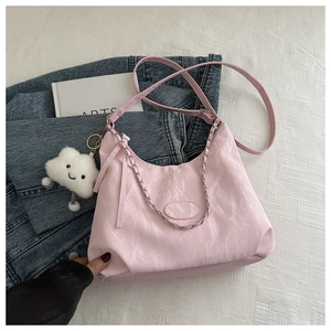 Pink pleated crossbody bag with silver chain and white cloud plush charm detail