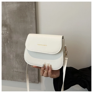 Detail of white saddle bag with golden Fashion & Bags text and metallic hook