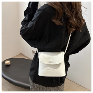 Back view of model wearing a white leather crossbody square bag with fashion text