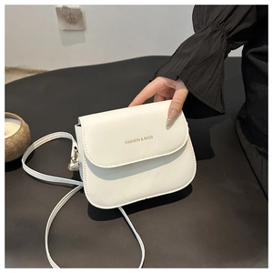 Close-up of white crossbody bag with gold Fashion & Bags logo and matte PU texture