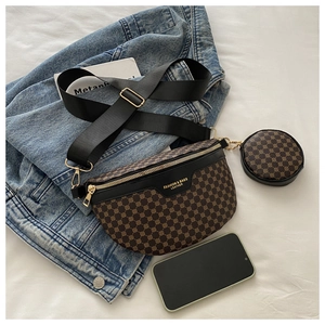 Detail of trendy crossbody waist bag with mini coin purse and golden zipper on white fabric