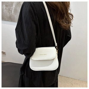 Rear view of model wearing white PU crossbody bag with golden FASHION & BAGS logo