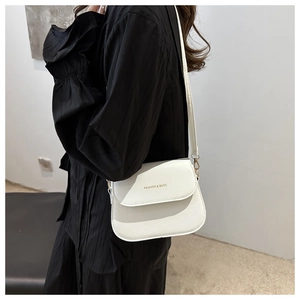 Close-up of white matte leather crossbody bag with golden Fashion & Bags logo lettering