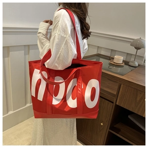 Detail of red large capacity tote bag with white noco lettering for casual daily use