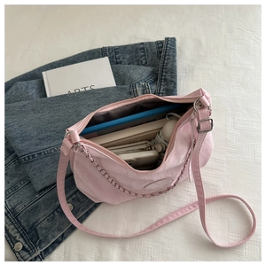 Pink crossbody tote interior showing capacity for tablet, wallet, and umbrella