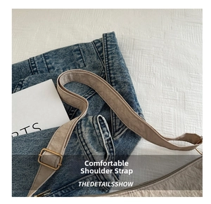 Close-up of comfortable textured shoulder strap with adjustable golden metal buckle