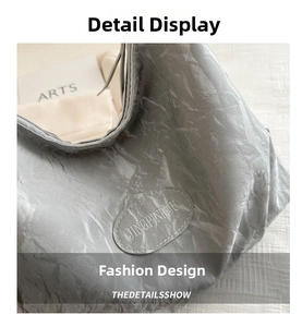 Close-up of silver-grey pleated texture fabric with JINGPINPIJU leather brand tag