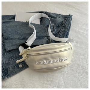 Detail of cream leather crossbody bag with embroidered letters and textured strap