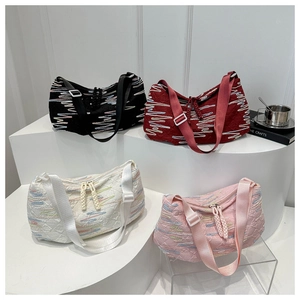 Quilted crossbody bag with colorful wave embroidery and adjustable strap in multiple colors