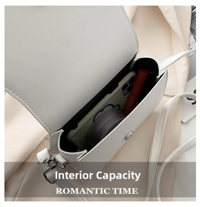 Interior view of white crossbody saddle bag showing capacity for phone and lipstick