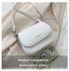Detail of white saddle bag showing leather texture, strap and silver metal hardware