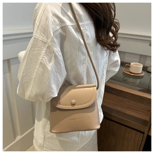 Detailed close-up of a beige bucket bag with 'FASHION & BAGS' text and slim strap