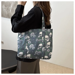 Close-up of gothic skull and lavender floral print on large canvas tote bag